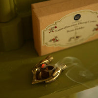 incense cones with brass holder by doing goods lit on table
